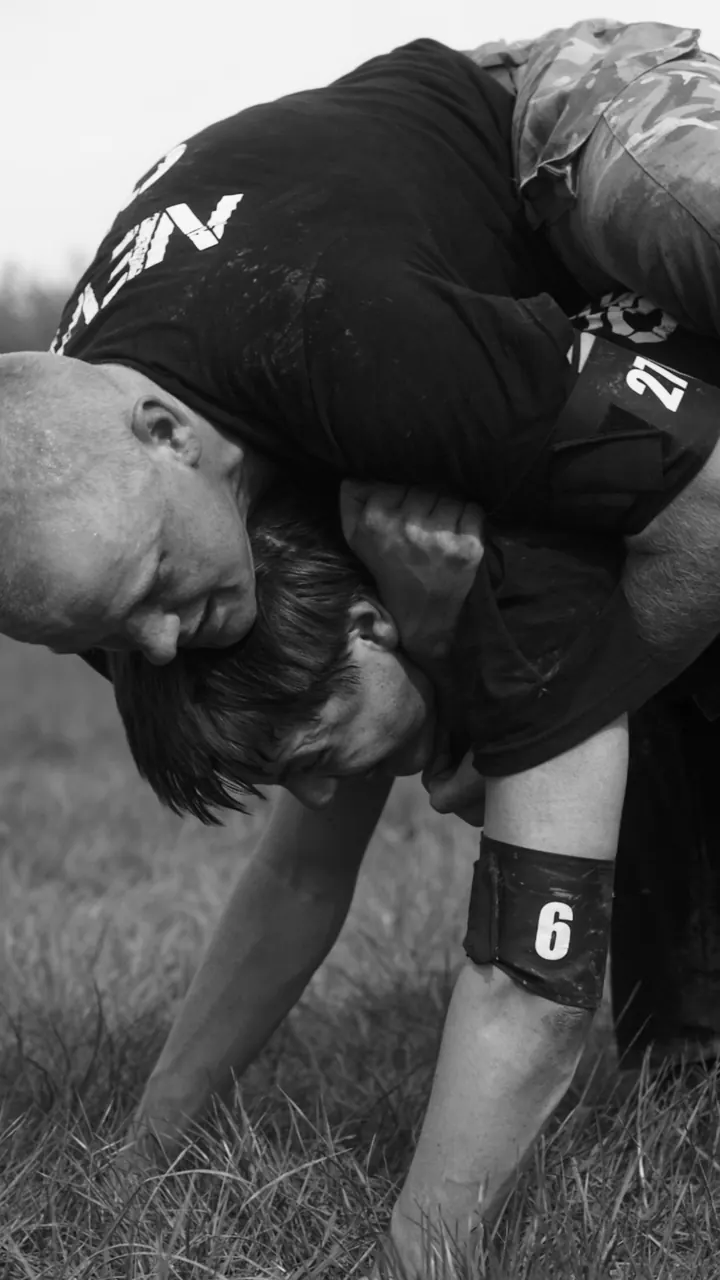 Two Civvy2Commando participants carrying each other during a field exercise