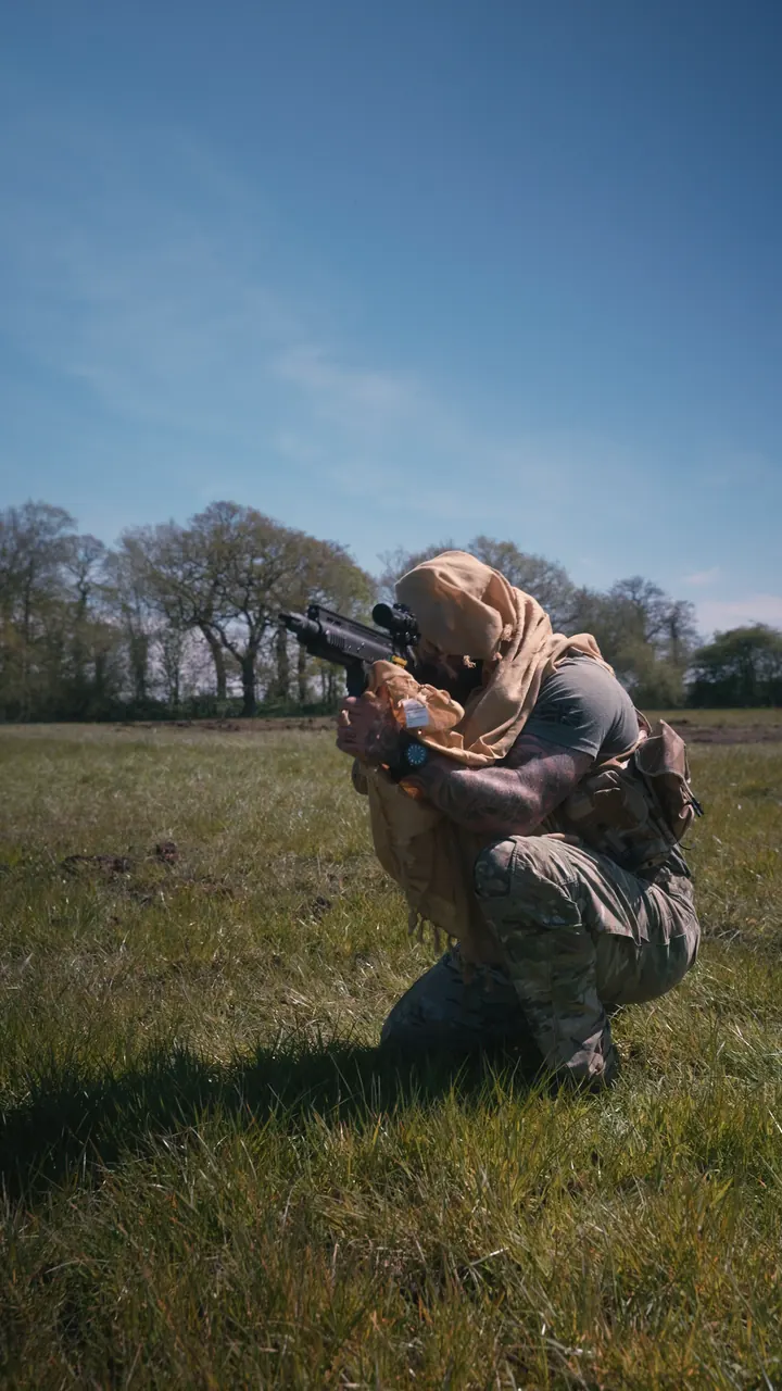 A Civvy2Commando instructor kneeling in a field